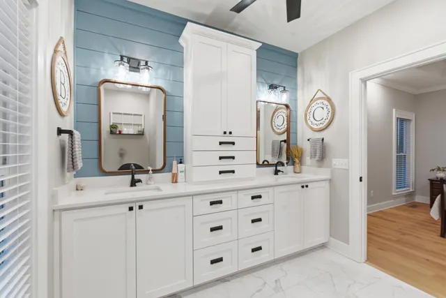 a bathroom with a double vanity sink and a mirror