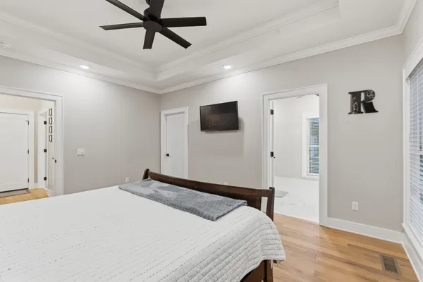 a bedroom with a bed and a flat screen tv