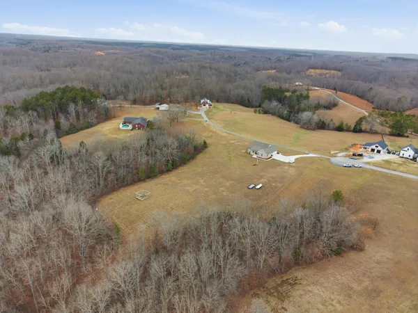 an aerial view of a houses with a yard