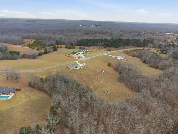 an aerial view of a houses with a yard
