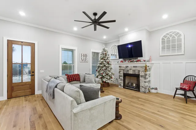 a living room with furniture a fireplace and a flat screen tv