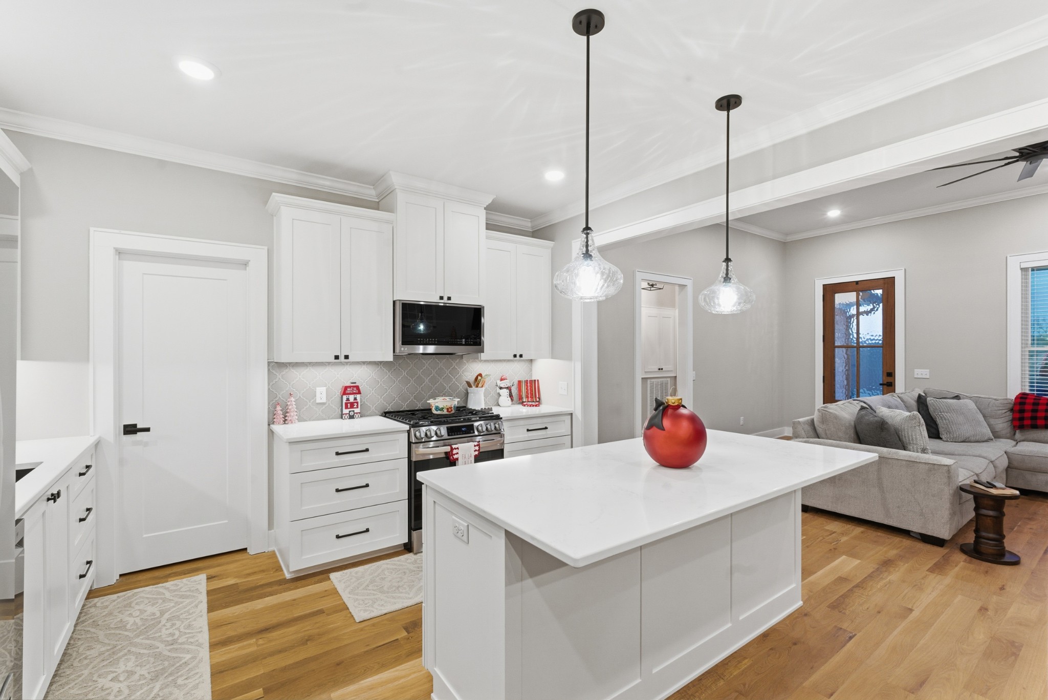 3055 Loren Lane Centerville, TN 37033 - Photo 8 of 40 a view of a kitchen with kitchen island a stove a sink dishwasher and a fireplace with wooden floor