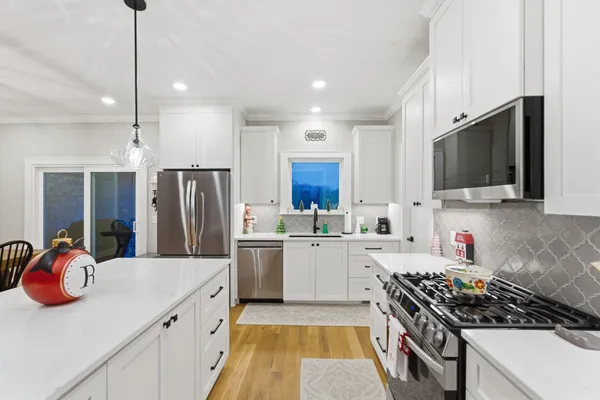 a kitchen with a sink a stove and refrigerator