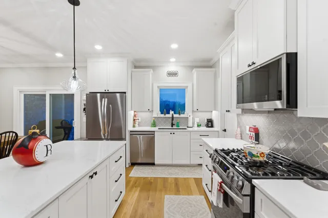 a kitchen with a sink a stove and refrigerator