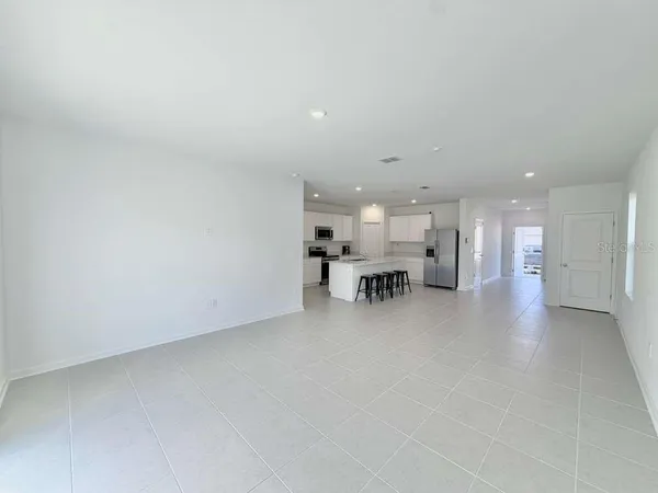 a view of kitchen and dining area with chandelier