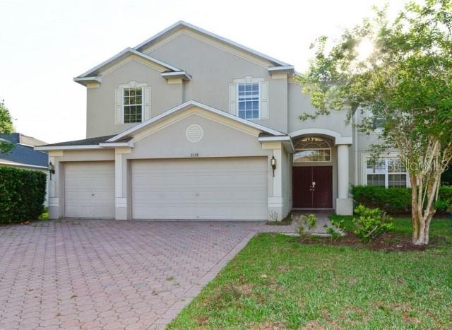 5159 Hartwell Loop Land O' Lakes, FL 34638 - Photo 1 of 1 a front view of house with yard and trees