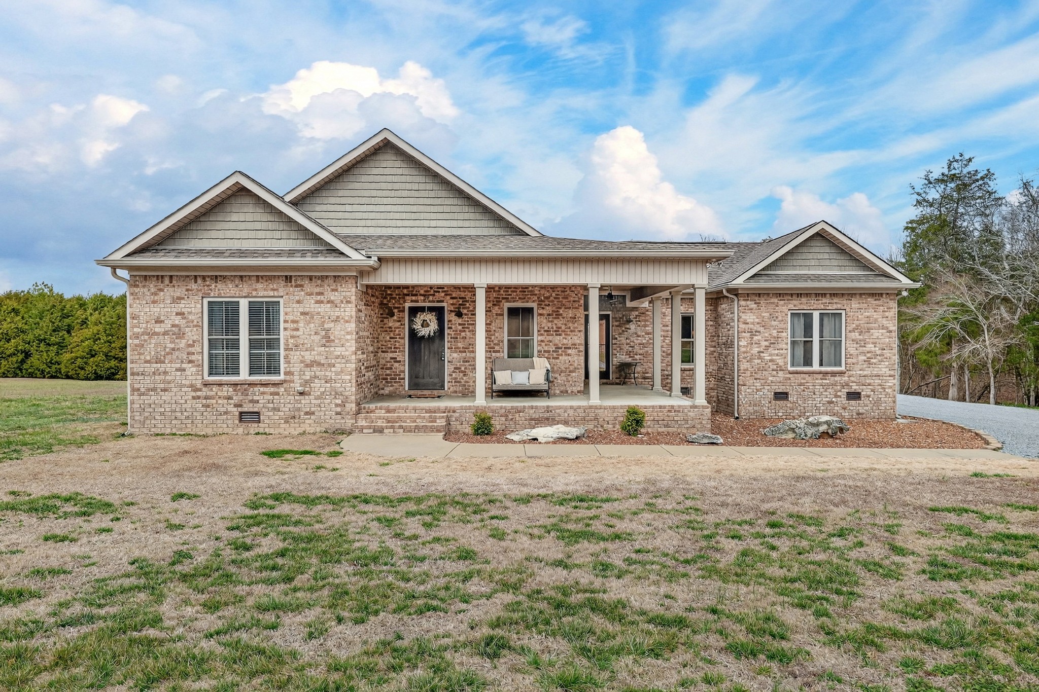 a front view of a house with a yard outdoor seating and garage