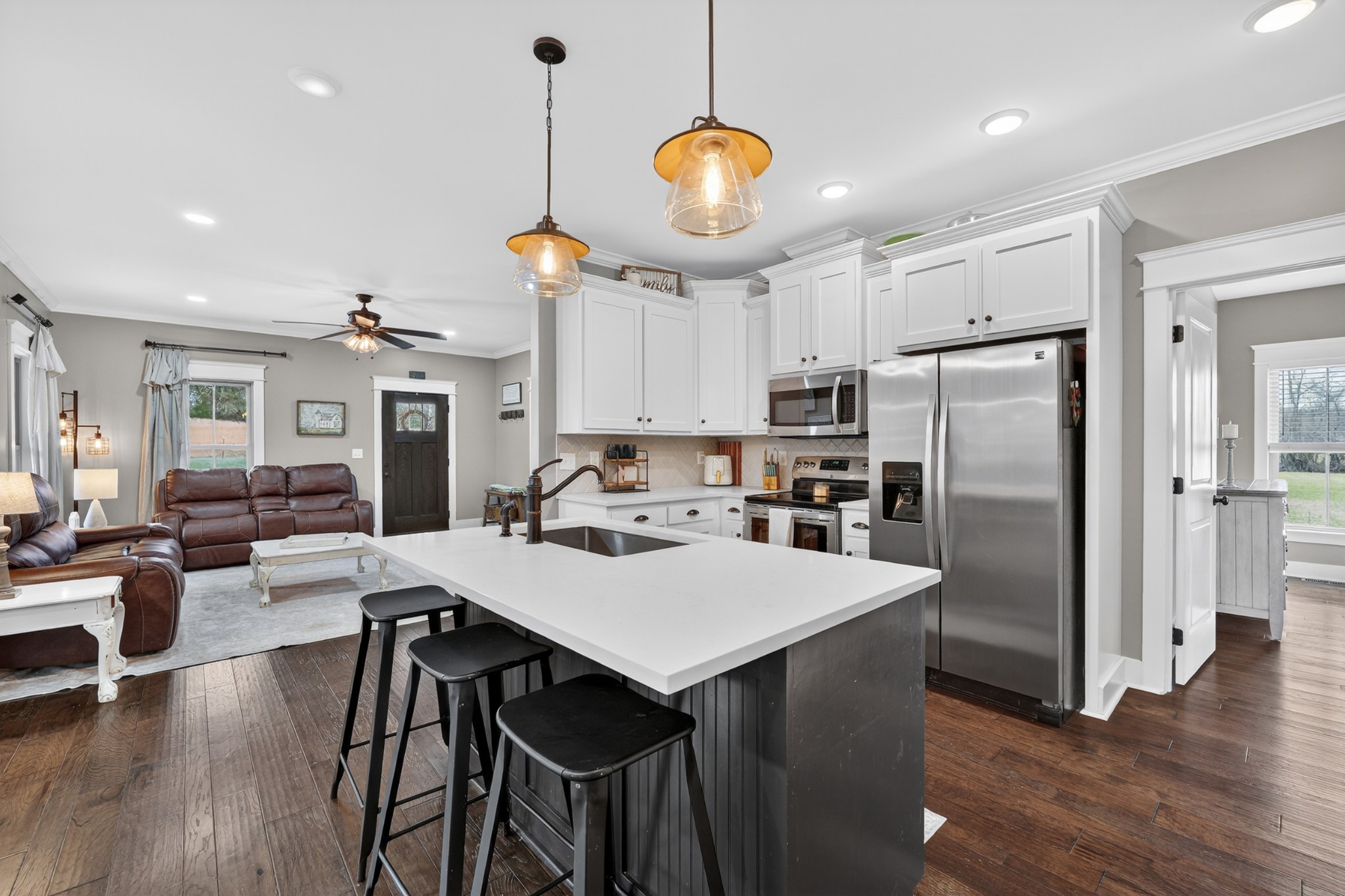 39 Boning Road Fayetteville, TN 37334 - Photo 14 of 43 a kitchen with stainless steel appliances granite countertop a stove a refrigerator a kitchen island a dining table and chairs with wooden floor