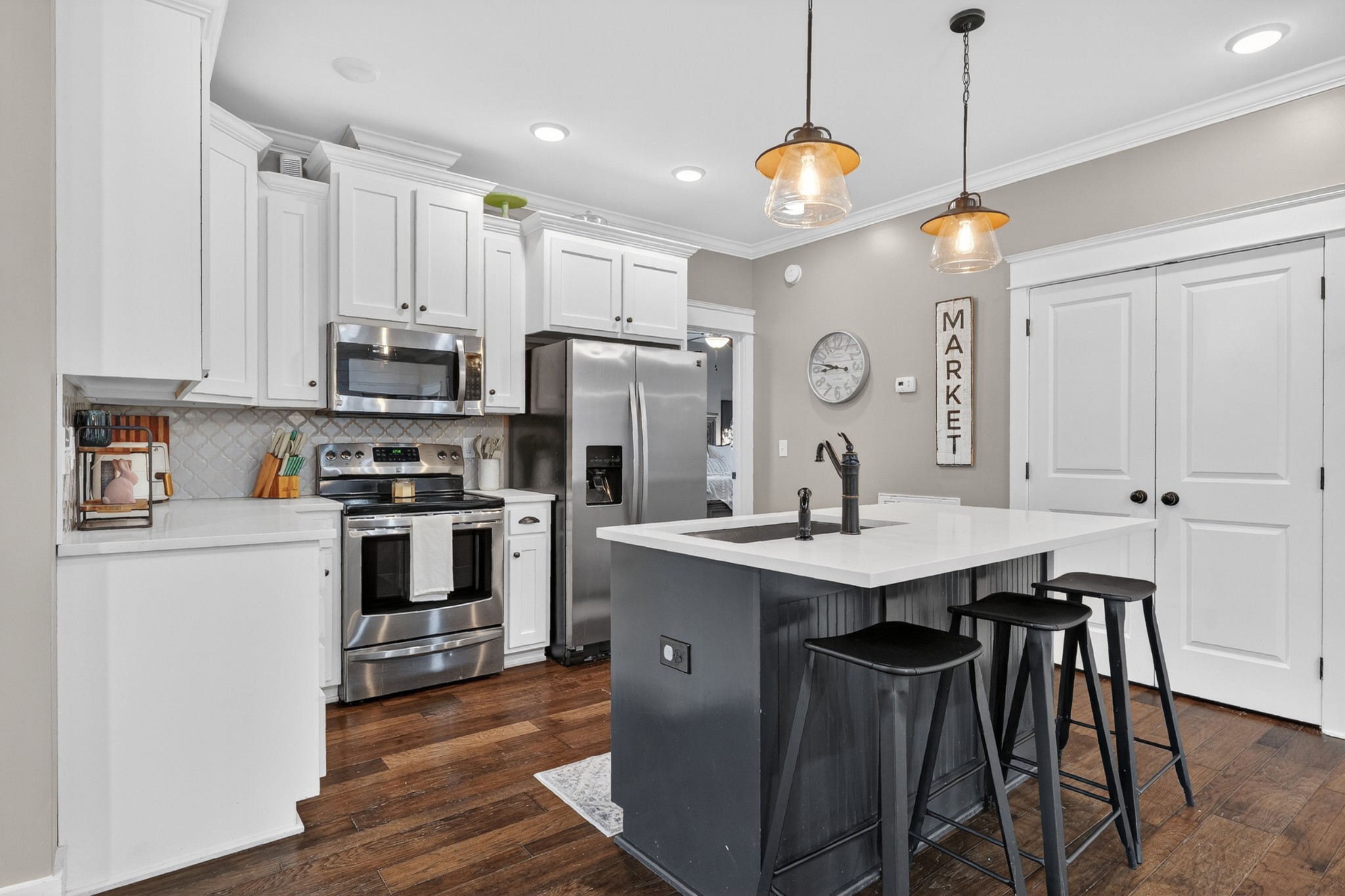 39 Boning Road Fayetteville, TN 37334 - Photo 16 of 43 a kitchen with stainless steel appliances granite countertop a sink a stove a refrigerator and island with wooden floor