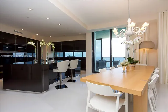 a dining room with furniture and a chandelier