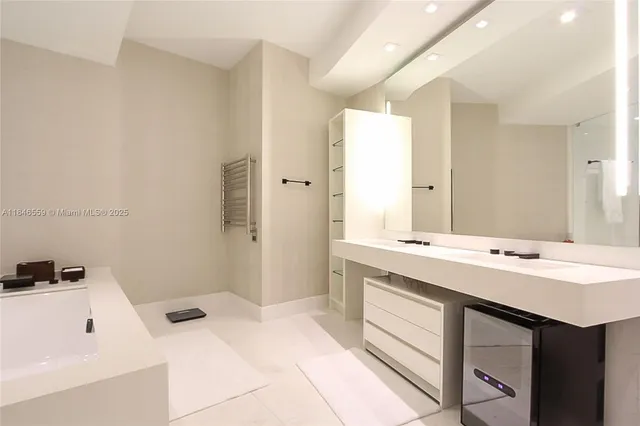 a bathroom with a sink a toilet and a large mirror