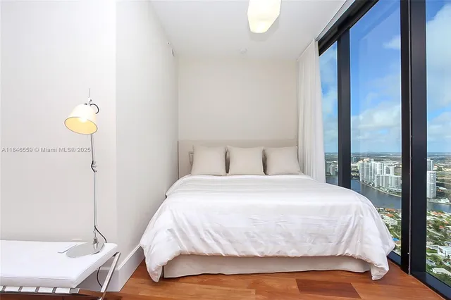 a spacious bedroom with a bed and a large window