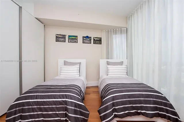 a bathroom with a granite countertop sink a toilet a mirror and shower