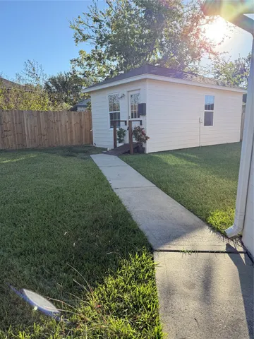 a view of a backyard with plants and a backyard