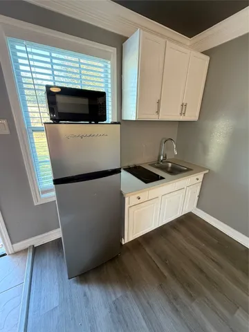 a kitchen with a sink and a microwave