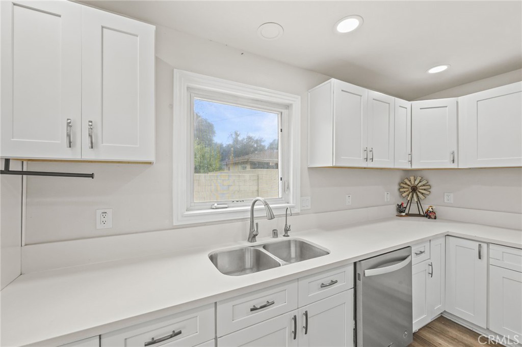 10028 Primrose Drive Riverside, CA 92503 - Photo 6 of 19 a kitchen with white cabinets and sink