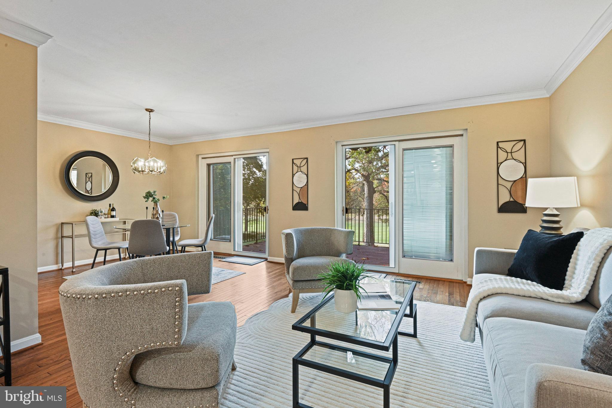 2180 Golf Course Drive Reston, VA 20191 - Photo 11 of 40 a living room with furniture a rug potted plant and a large window