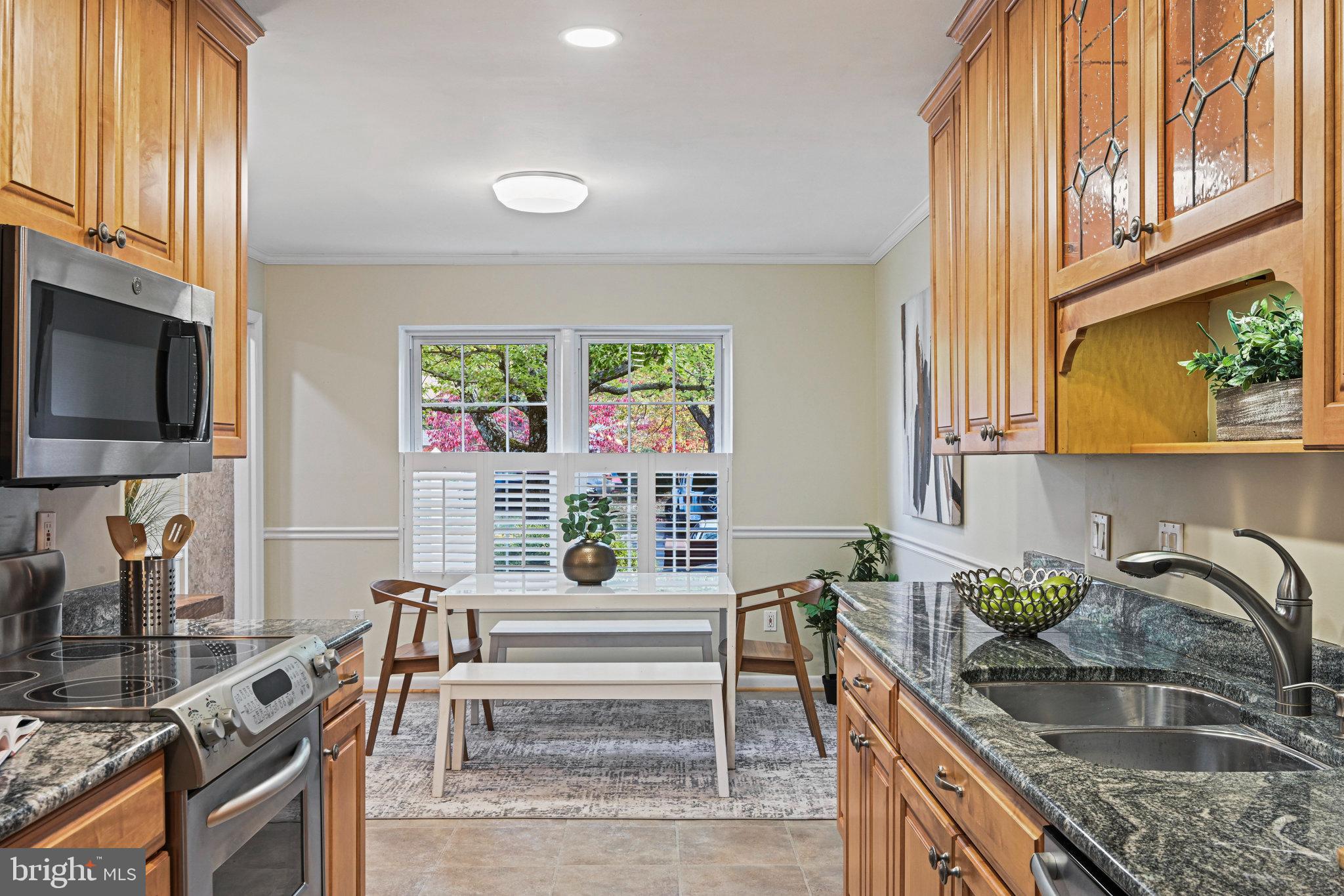2180 Golf Course Drive Reston, VA 20191 - Photo 13 of 40 a kitchen with granite countertop a sink a counter top space and stainless steel appliances