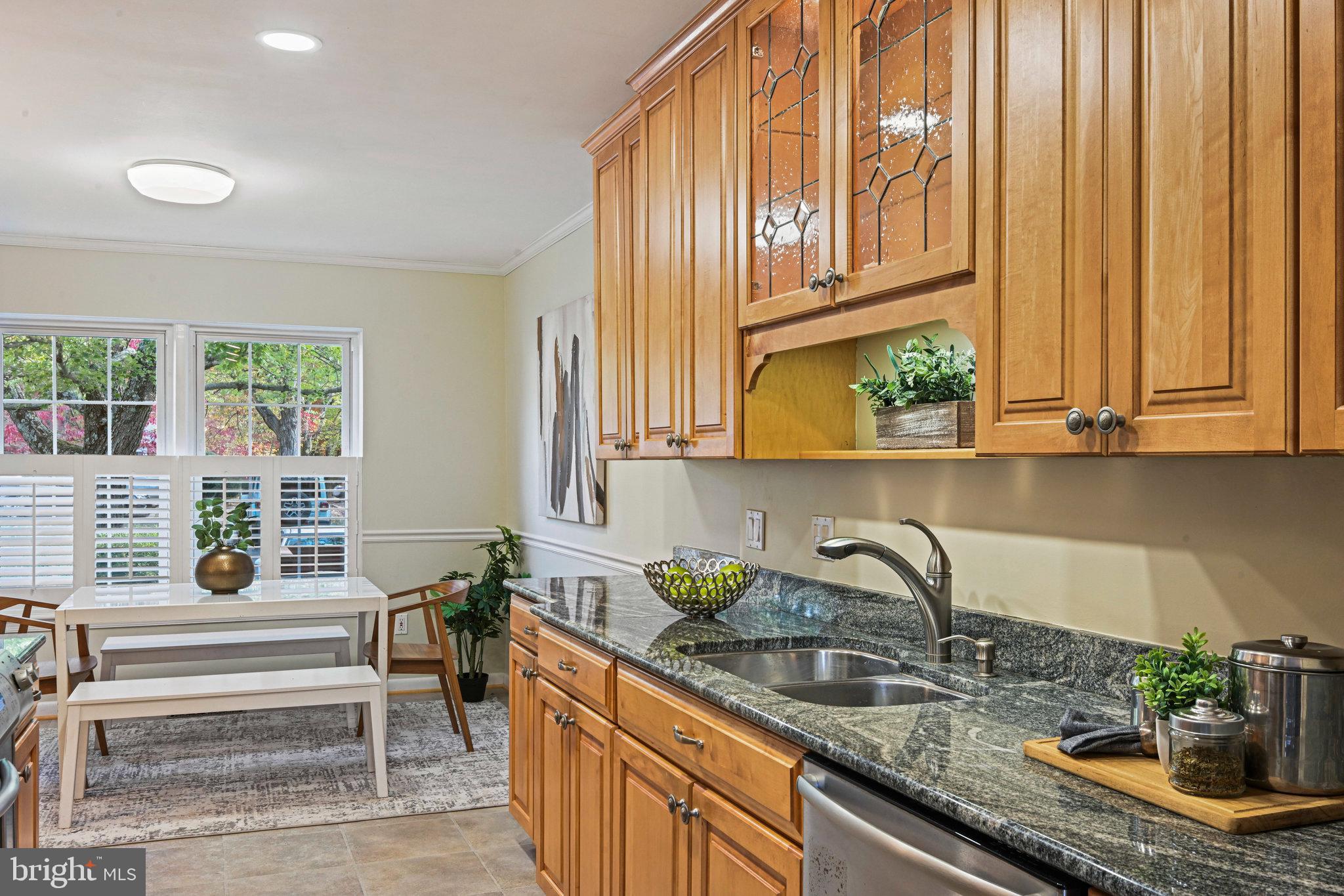 2180 Golf Course Drive Reston, VA 20191 - Photo 14 of 40 a kitchen with stainless steel appliances granite countertop a sink a counter space and cabinets