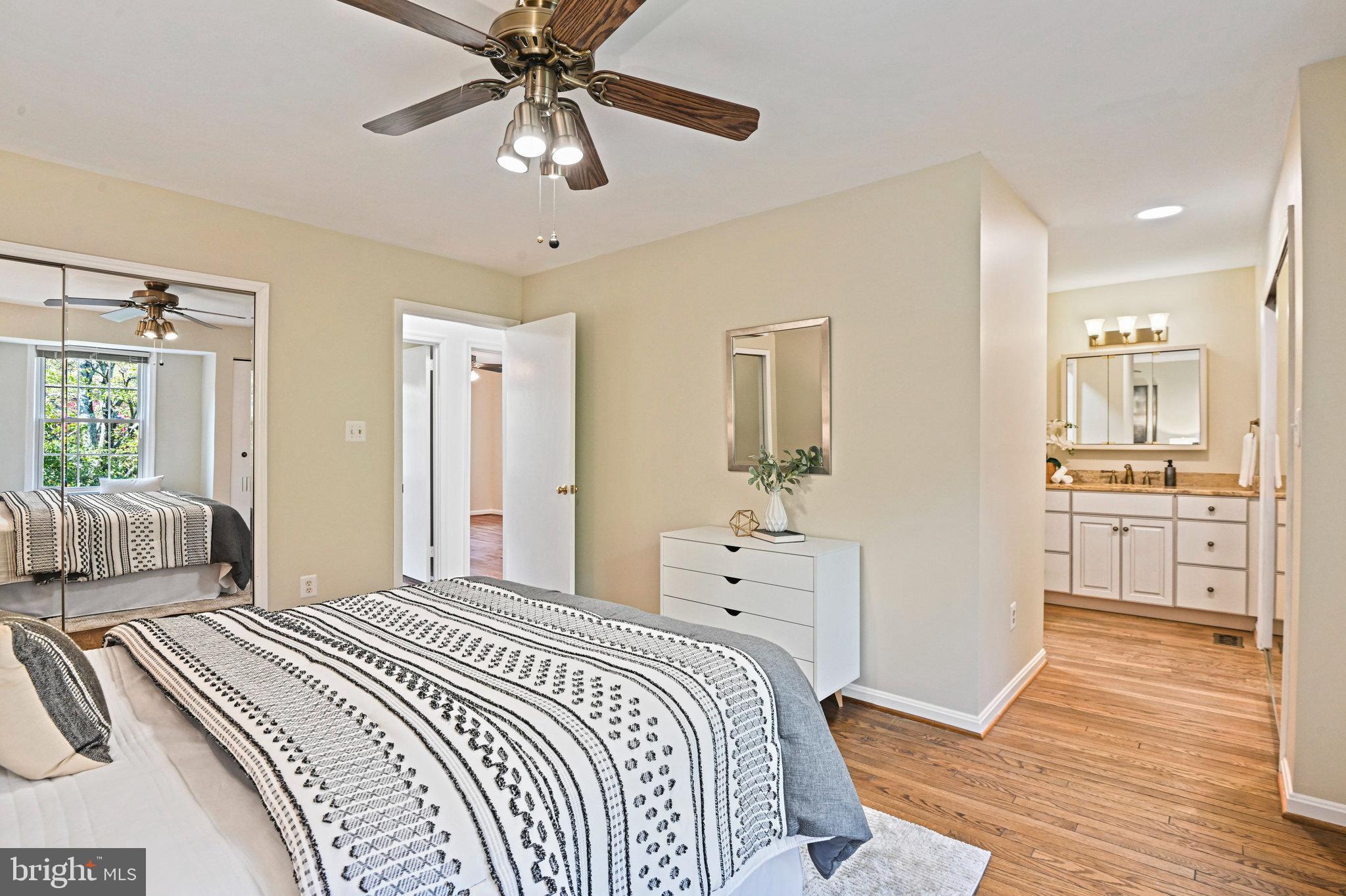 2180 Golf Course Drive Reston, VA 20191 - Photo 16 of 40 a bedroom with a bed and a chandelier