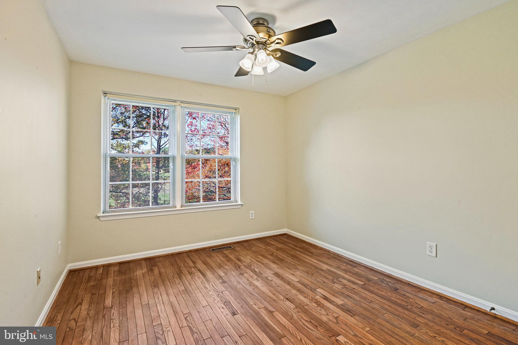 2180 Golf Course Drive Reston, VA 20191 - Photo 21 of 40 an empty room with a window and a ceiling fan