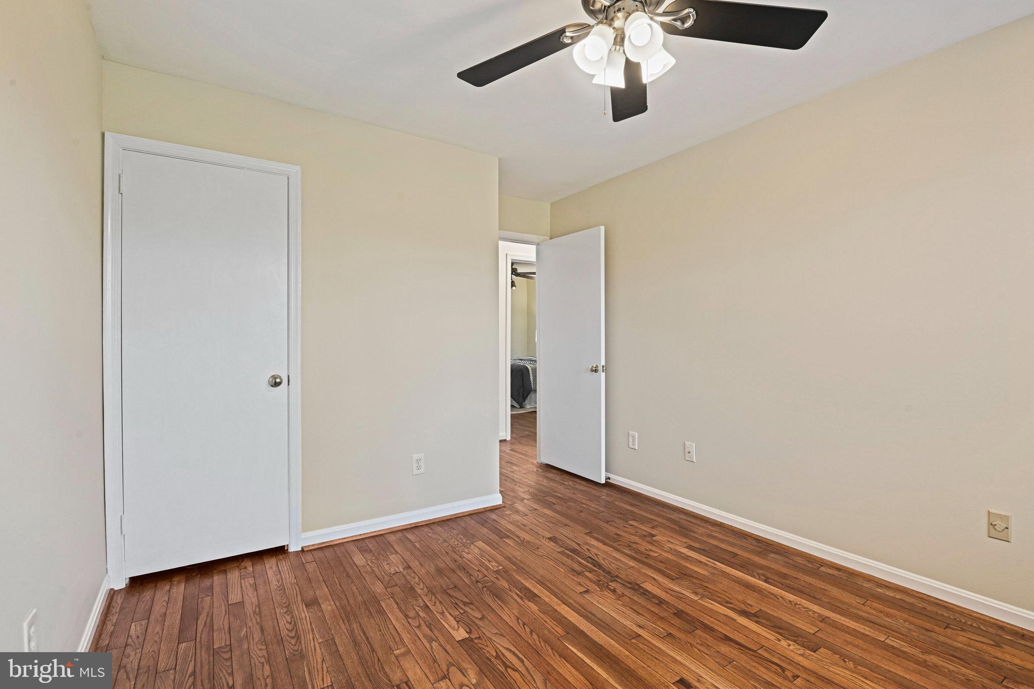 2180 Golf Course Drive Reston, VA 20191 - Photo 22 of 40 an empty room with wooden floor a ceiling fan and closet