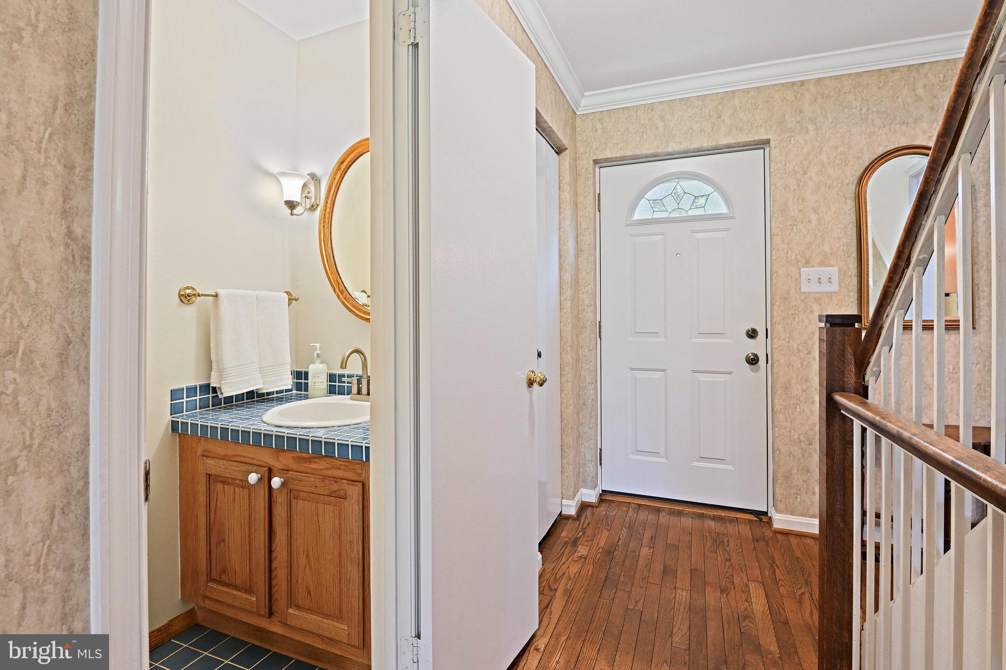 2180 Golf Course Drive Reston, VA 20191 - Photo 25 of 40 a view of front door with hallway and wooden floor