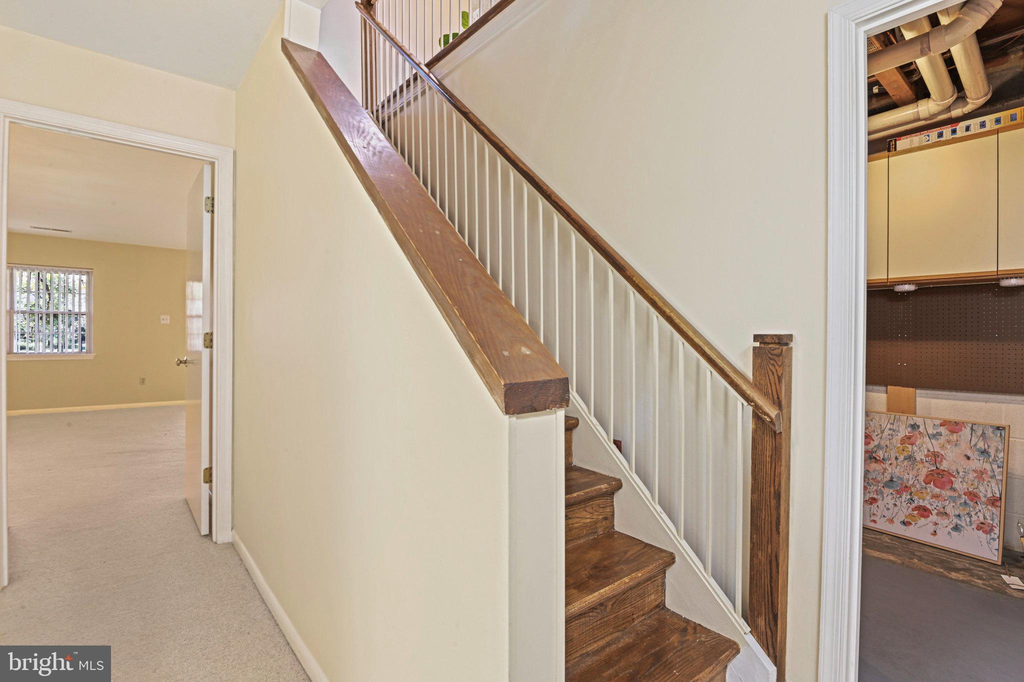 2180 Golf Course Drive Reston, VA 20191 - Photo 32 of 40 a view of a hallway with wooden floor and stairs
