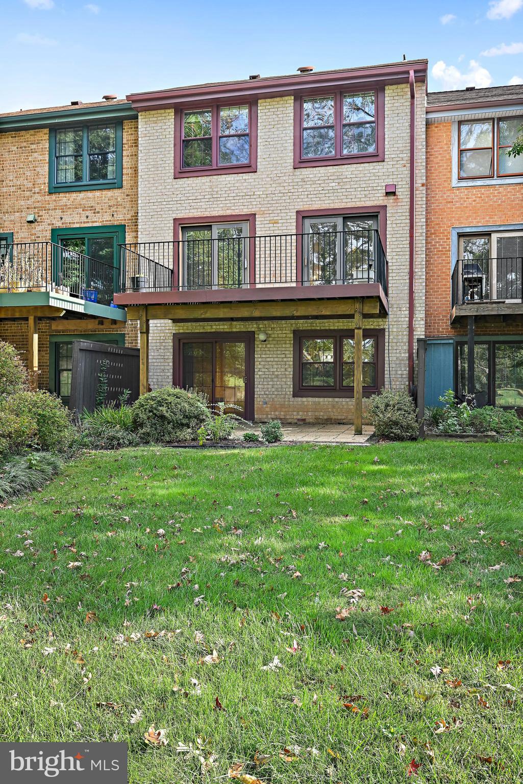 2180 Golf Course Drive Reston, VA 20191 - Photo 35 of 40 a front view of a residential apartment building with a yard