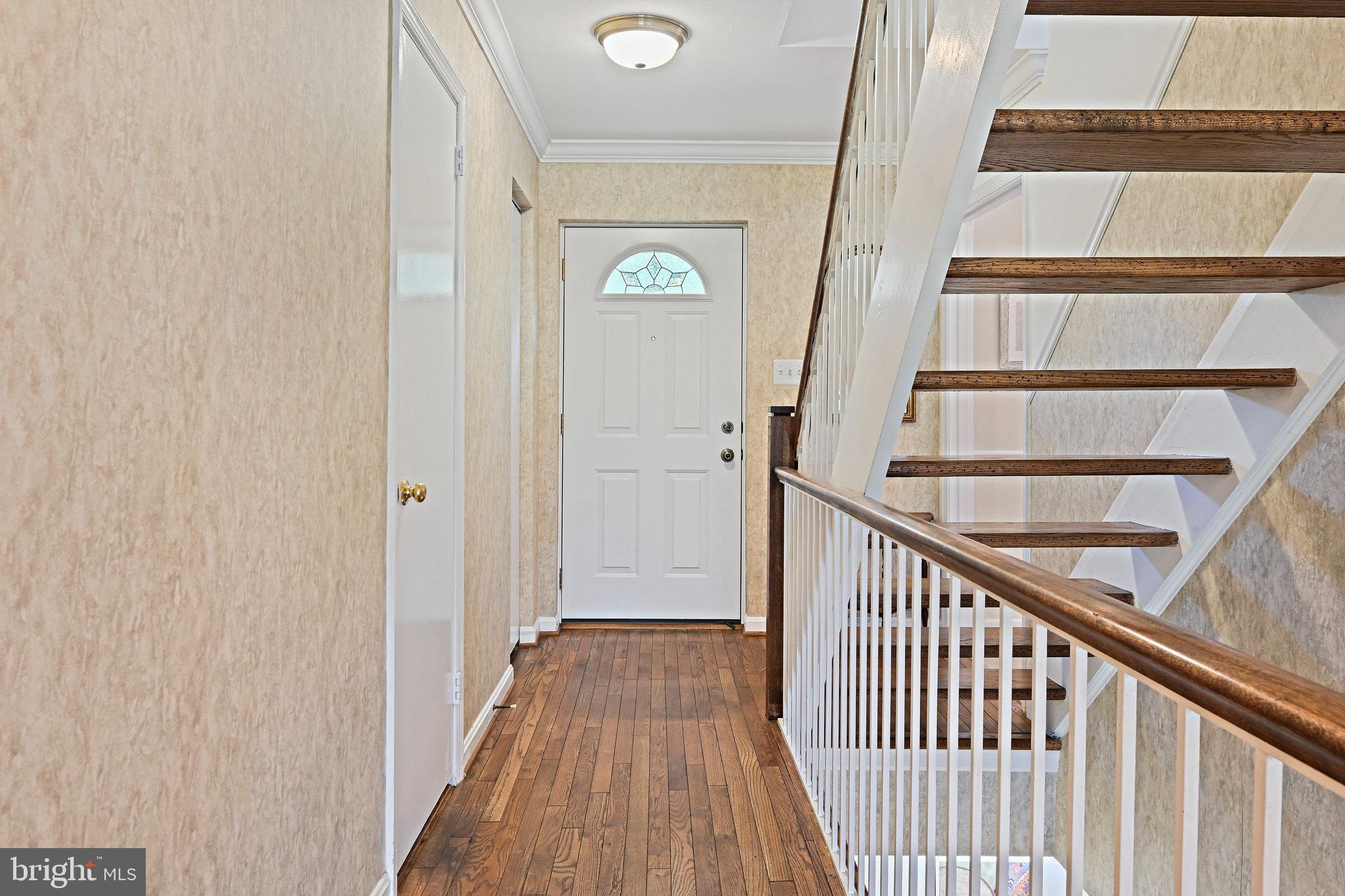2180 Golf Course Drive Reston, VA 20191 - Photo 5 of 40 a view of a hallway with wooden floor and entryway