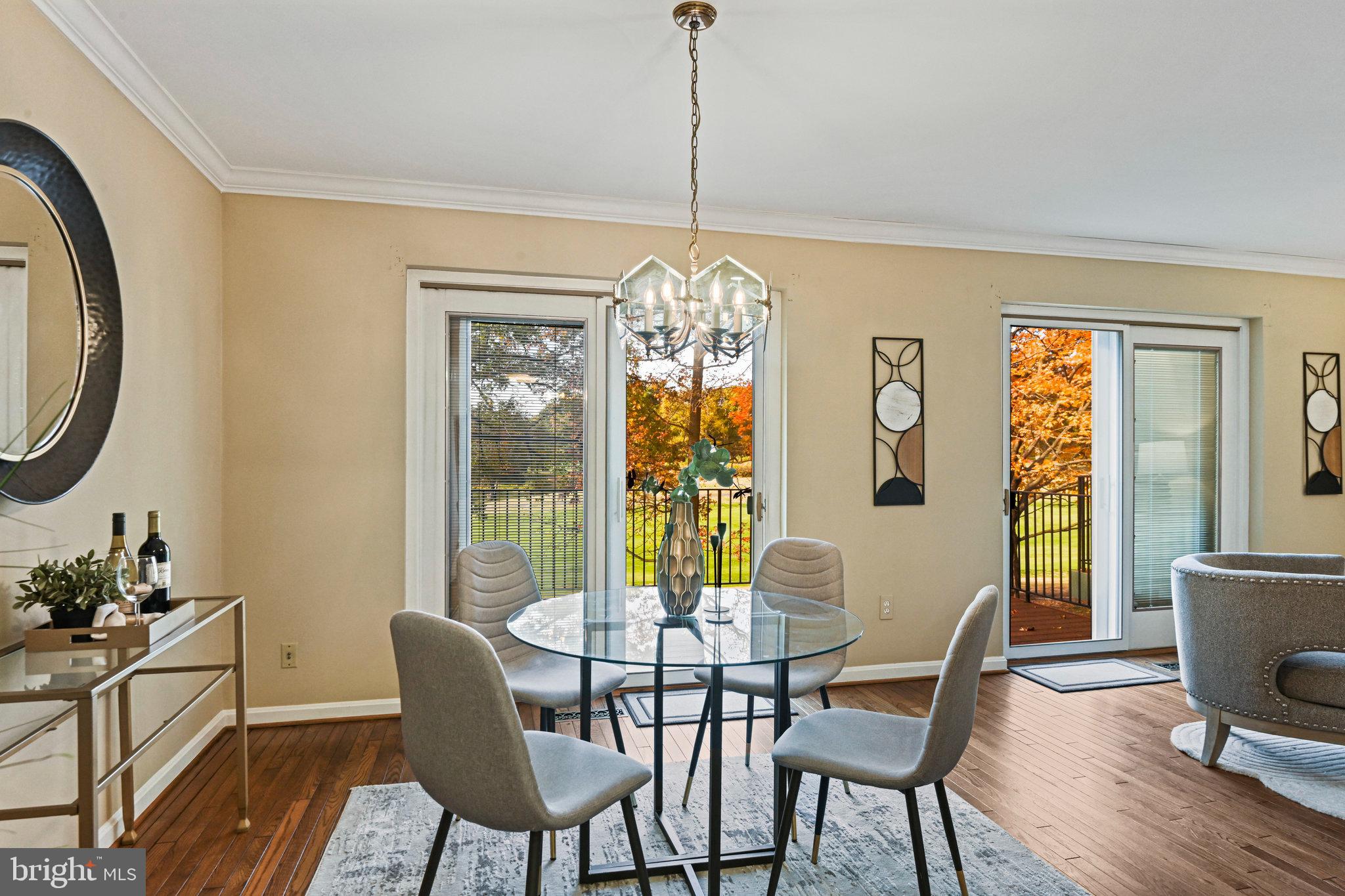 2180 Golf Course Drive Reston, VA 20191 - Photo 8 of 40 a dining room with furniture a chandelier and wooden floor