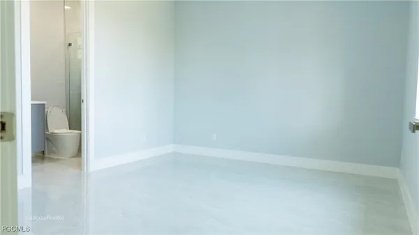 a view of an empty room and a bathroom