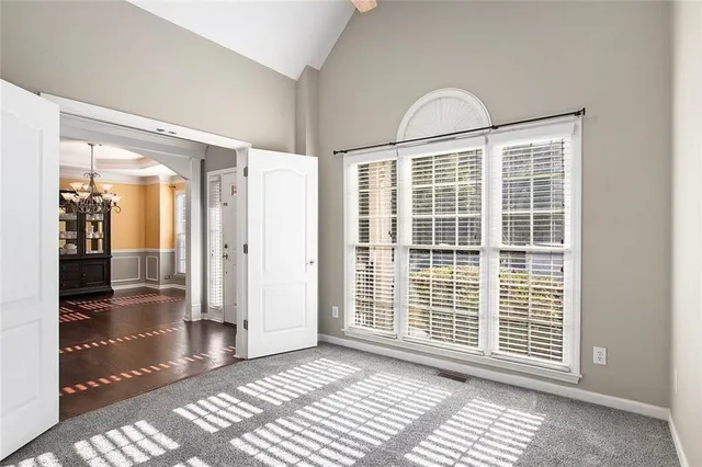 a view of a livingroom with wooden floor and a window