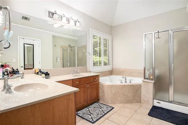 a spacious bathroom with a double vanity sink and a mirror