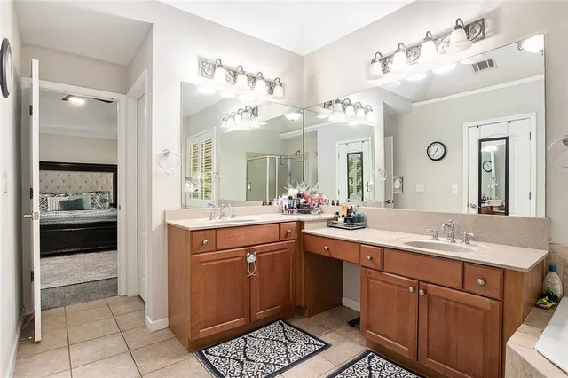 a bathroom with a tub a sink shower and mirror