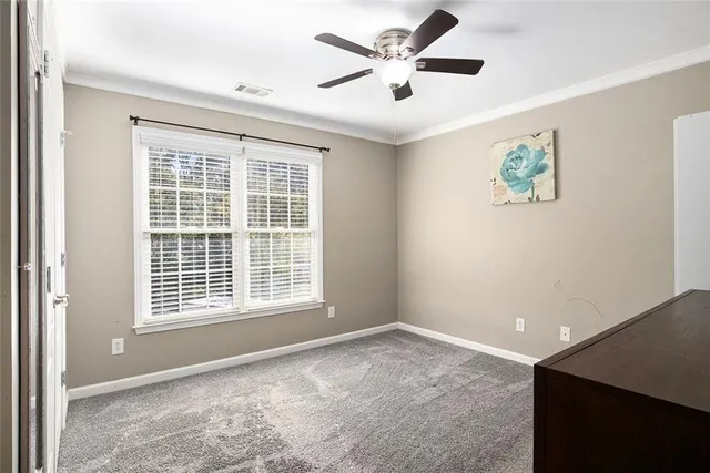 a view of a bedroom with furniture and a ceiling fan