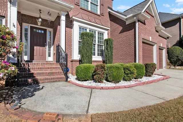 a view of a house with potted plants
