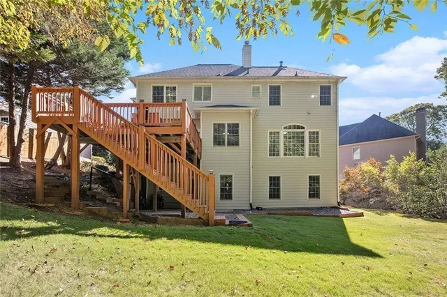 a view of a house with yard and basketball court