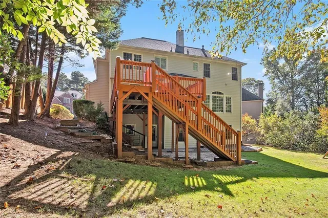 a view of a house with a chairs and table in a patio