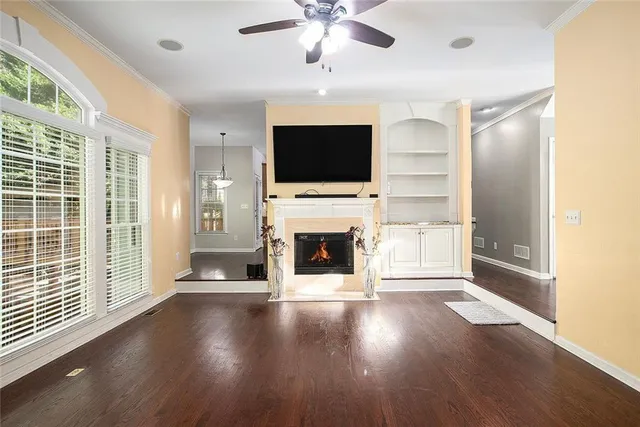 a living room with fireplace flat screen tv and outdoor space