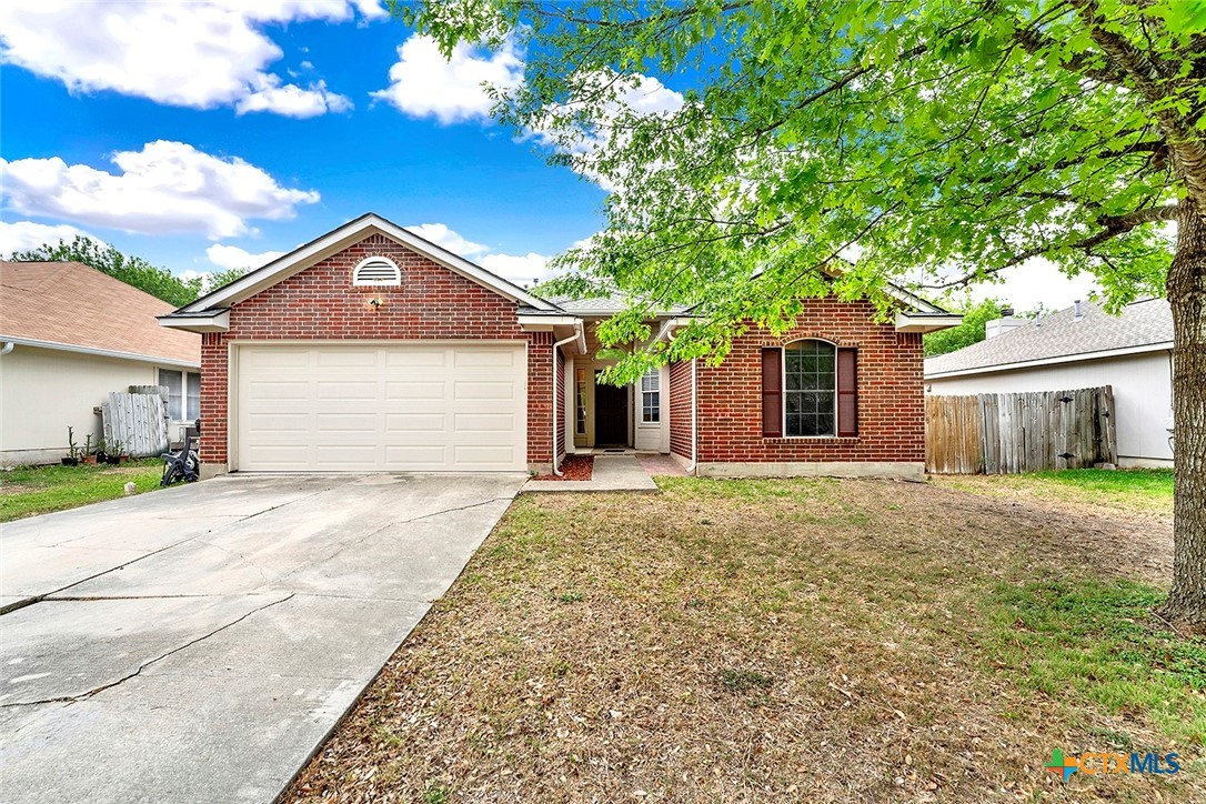 140 Riley Cove Kyle, TX 78640 - Photo 2 of 26 a front view of a house with a yard and garage