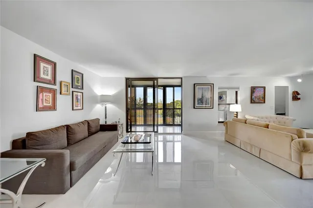 a bathroom with a granite countertop double vanity sink and a mirror