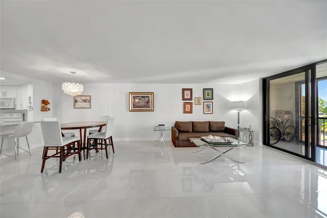 a view of a kitchen with a floor to ceiling window and an empty room