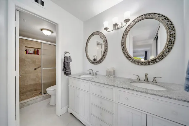 an aerial view of a tennis ground with large trees