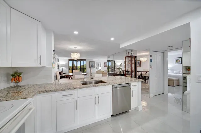 a livingroom with furniture and a floor to ceiling window