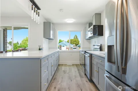 a kitchen with stainless steel appliances a refrigerator and a sink