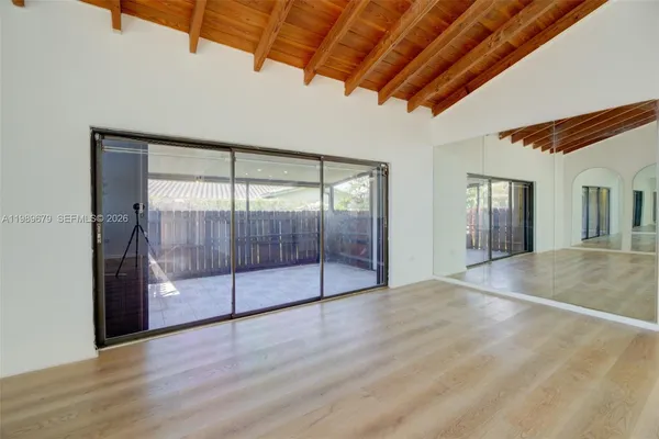 a view of an empty room with glass door