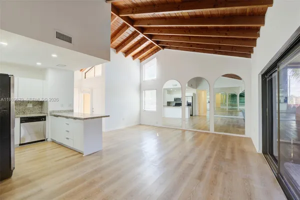 a view of a kitchen with a sink and a stove top oven
