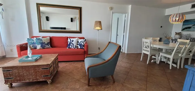 a living room with furniture and a painting on the wall