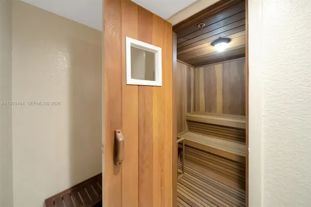 a spacious bedroom with a bed and a chandelier